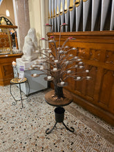 Side view of the steel prayer candle tree with candles in place