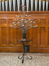 Front view of Metal Relic's steel prayer candle tree with attached table and bucket at St. Luke's Church